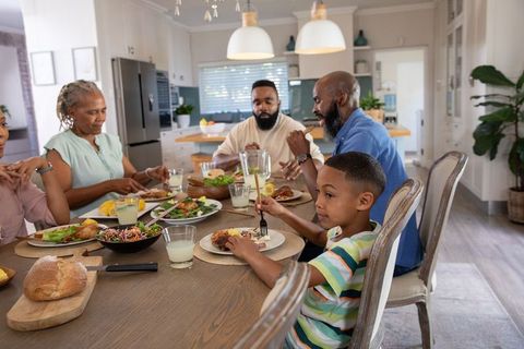 Family Enjoying Meal Around Dining Table in Modern Kitchen