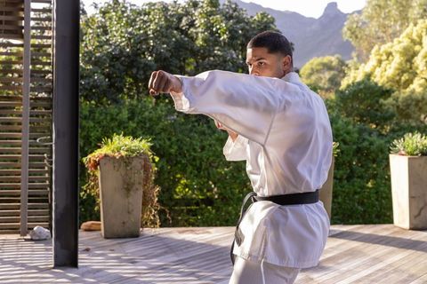 Martial Arts Practitioner in White Gi Demonstrating Powerful Punch