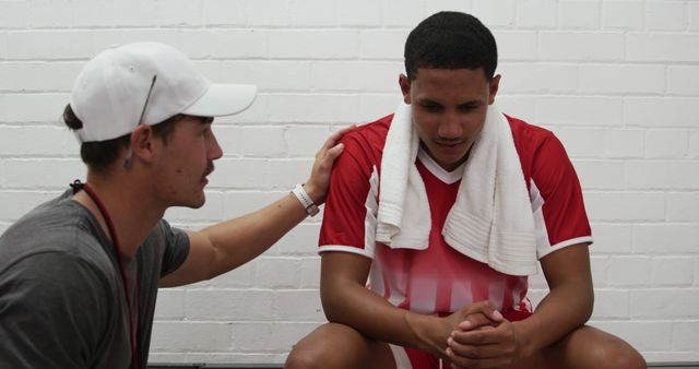 Coach Supporting Depressed Soccer Player in Locker Room - Download Free Stock Images Pikwizard.com