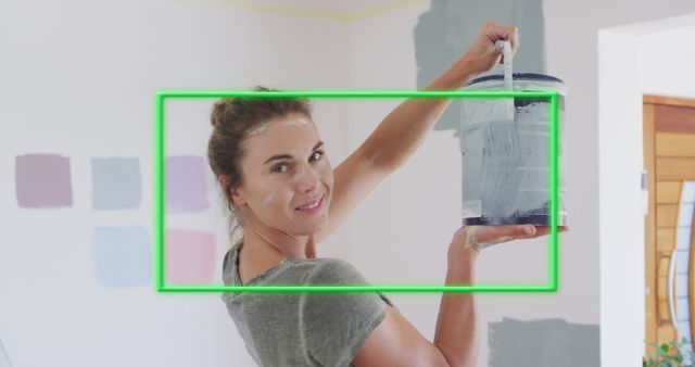 Image of green frame over caucasian woman holding paint - Download Free Stock Photos Pikwizard.com