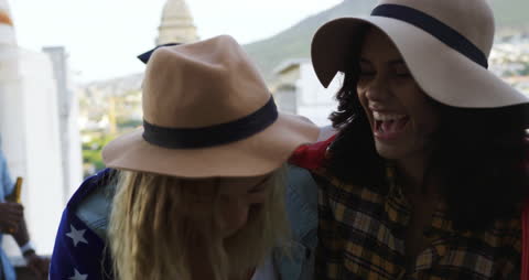 Cheerful Friends Enjoying Rooftop Party with American Flag