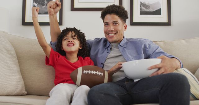 Cheerful Father and Son Watching Football Game at Home - Download Free Stock Images Pikwizard.com