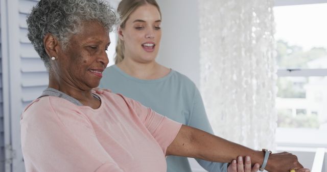 Senior Woman Receiving Assistance with Arm Stretching Exercise - Download Free Stock Images Pikwizard.com