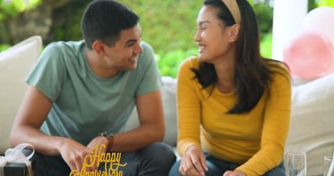 Happy Young Couple Mingling on Cozy Sofa Enjoying Time Together