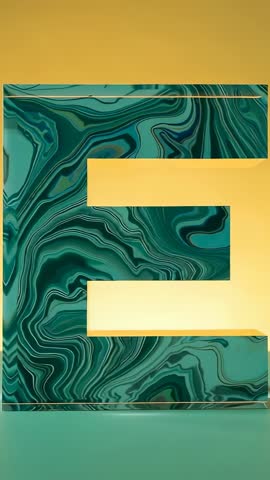 Vertical video featuring marbled 3D letter E with glowing gold cutouts and shifting light