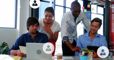 Diverse Team Collaborating on Tech Devices in Modern Office