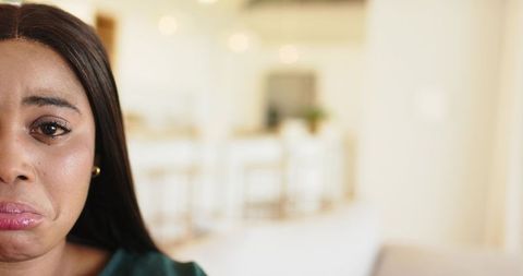 Close-up african american woman crying and pouting in modern kitchen with copy space