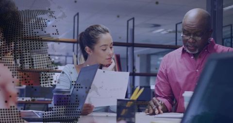 Diverse Team Collaborating in Modern Office with Digital Graphics