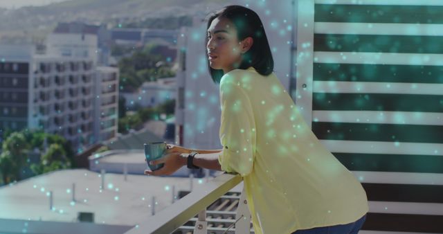 Image of light spots over biracial woman drinking coffee on balcony. national relaxation day and celebration concept digitally generated image.