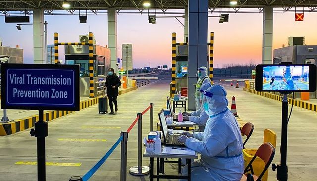 Medical staff conducting viral screening at toll plaza viral transmission prevention zone