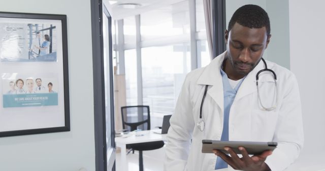 Confident Doctor Reviewing Patient Records on Digital Tablet in Medical Office - Download Free Stock Images Pikwizard.com