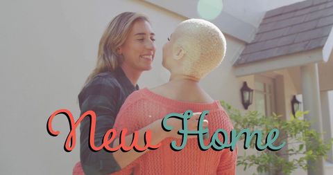Lesbian Couple Embracing in Front of New House