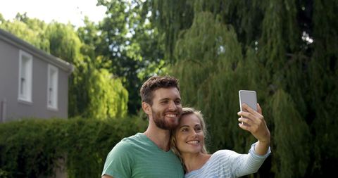 Happy Couple Taking Selfie in Outdoor Garden