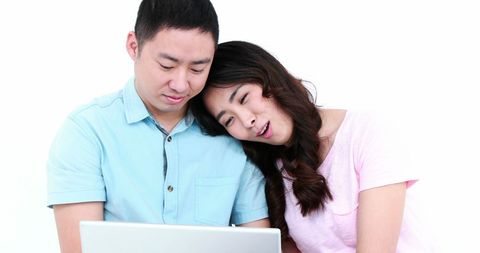 Asian Couple Enjoying Togetherness with Laptop