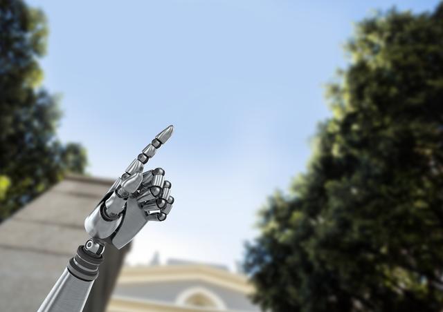 This image shows an android robot hand pointing towards the sky with a background of trees and a building. It can be used to represent themes of technology, artificial intelligence, and the future. Ideal for use in articles, presentations, and marketing materials related to robotics, innovation, and the integration of technology with nature.