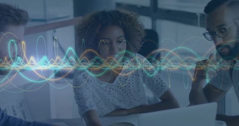 Team Collaborating Over Laptop with Dynamic Waveform Data Visualization for Analytics