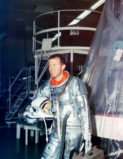 S63-01922 (1963) --- Astronaut L. Gordon Cooper Jr., pilot for the Mercury-Atlas 9 (MA-9) mission, stands fully suited beside his spacecraft during preflight testing. Cooper named his spacecraft the Faith 7. Photo credit: NASA