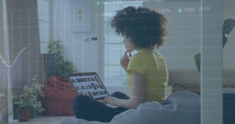 Businesswoman Analyzing Financial Data on Laptop at Home