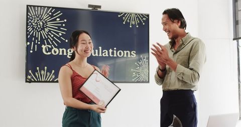 Colleagues celebrating employee recognition with applause