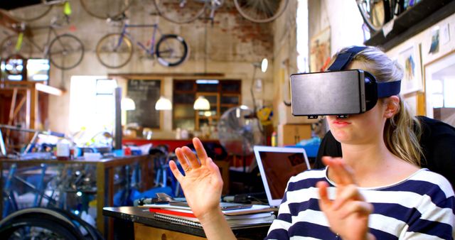 Woman Experiencing Virtual Reality in Creative Studio with Bicycles - Download Free Stock Images Pikwizard.com
