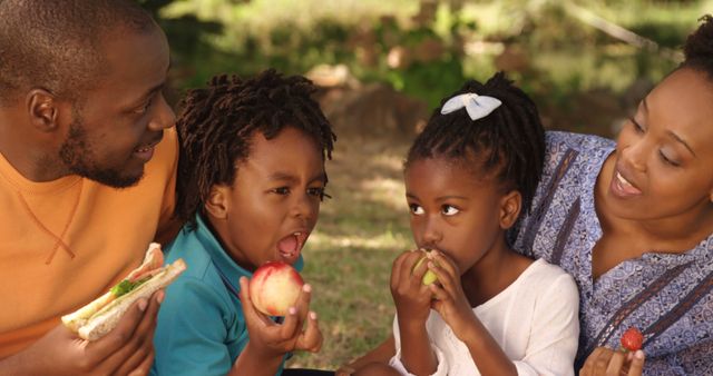 Happy Family Enjoying Picnic Outdoors and Eating Fruits - Download Free Stock Images Pikwizard.com