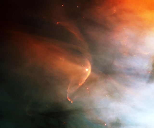 The nearby intense star-forming region known as the Great Nebula in the Orion constellation reveals a bow shock around a very young star as seen by NASA's Hubble Space Telescope (HST). Named for the crescent-shaped wave made by a ship as it moves through the water, a bow shock can be created in space where two streams of gas collide. LL Ori emits a vigorous solar wind, a stream of charged particles moving rapidly outward from the star. Our own sun has a less energetic version of this wind. The material in the fast wind from LL Ori collides with slow moving gas evaporating away form the center of the Orion Nebula, which is located in the lower right of this image, producing the crescent shaped bow shock seen in the image. Astronomers have identified numerous shock fronts in this complex star-forming region and are using this data to understand the many complex phenomena associated with the birth of stars. A close visitor in our Milky Way Galaxy, the nebula is only 1,500 light years away from Earth. The filters used in this color composite represent oxygen, nitrogen, and hydrogen emissions.