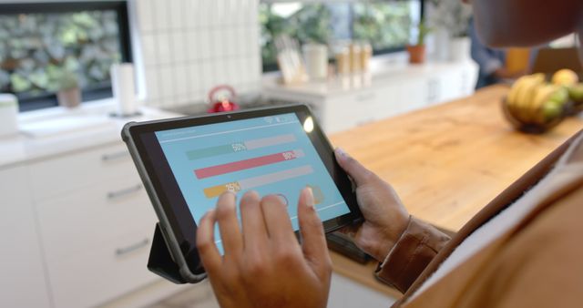 Person Analyzing Data on Digital Tablet in Modern Kitchen - Download Free Stock Images Pikwizard.com