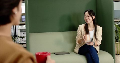 Relaxed office chat amidst casual workspace vibe