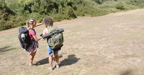 Women Hiking Adventure in Sunny Grassland Landscape - Download Free Stock Images Pikwizard.com