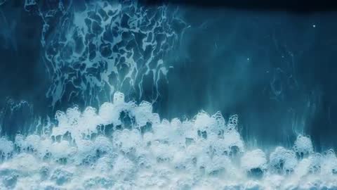 Aerial View of Ocean's Powerful Wave Crashing into Foam
