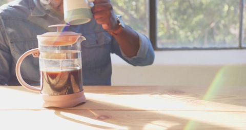 Sunlit Workspace with French Press Coffee for Relaxed Productivity