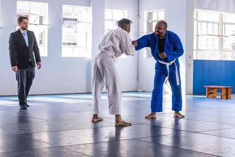 Martial Arts Training Session with Athletes on Mats in Professional Dojo