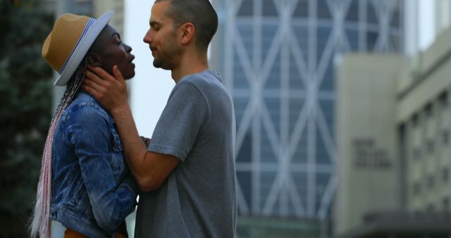 Interracial couple embracing romantically in urban setting - Download Free Stock Images Pikwizard.com