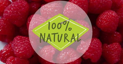 100 percent natural label on fresh raspberries background