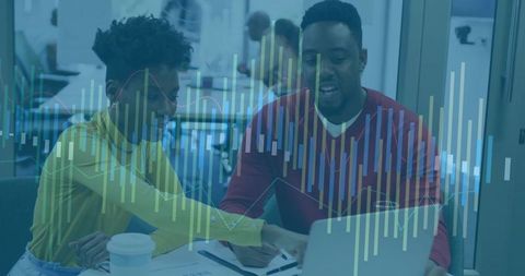 Collaborating professionals analyzing financial charts on laptop with data overlay