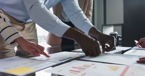 Team Analyzing Data Charts in Management Meeting