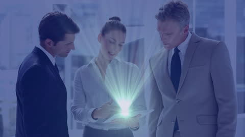 Team of Business Professionals Reviewing Illuminated Tablet