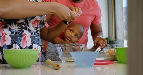 Family Cooking Time with Mother and Son, Cracking Eggs in Kitchen