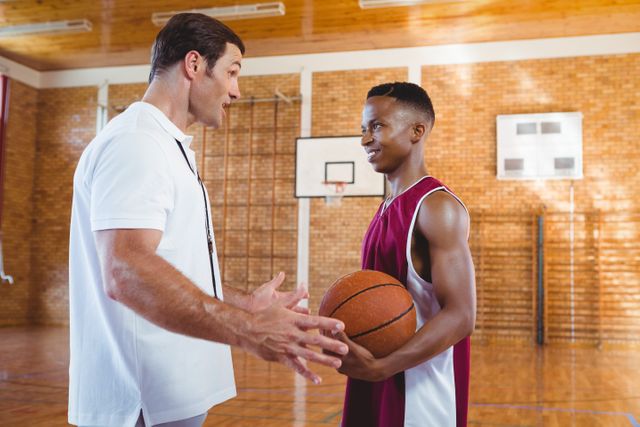 Coach talking with basketball player - Download Free Stock Photos Pikwizard.com