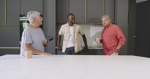 Diverse Multigenerational Family Chatting Over Coffee at Modern Marble Kitchen Island