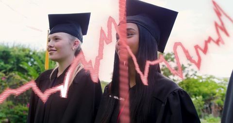 Graduation duo standing in caps and gowns with red stock market chart overlay