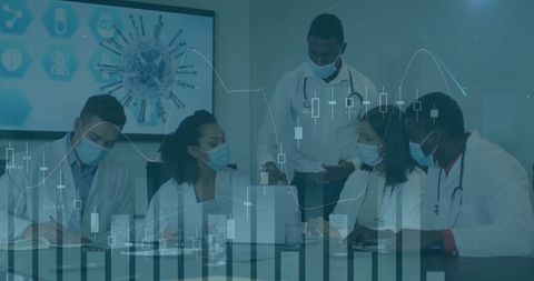 Multicultural medical team analyzing healthcare data and charts in collaborative meeting