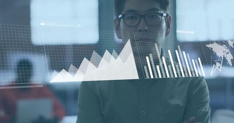 Asian businessman analyzing financial data visualization in modern office