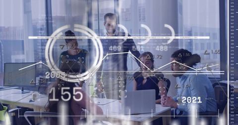 Presenting manager leading team through analytics dashboard with laptop in glass boardroom