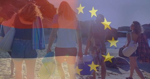 Friends strolling on beach with cooler under eu and armenian flags