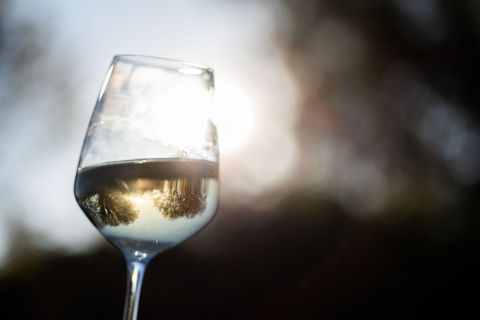 Elegant Wine Glass Reflecting Sunset Outdoors
