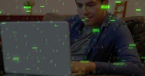 Man working from home with laptop and digital binary overlay