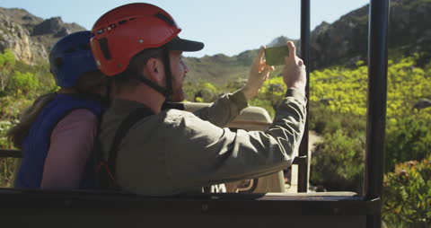 Couple Capturing Mountain Adventure With Smartphone