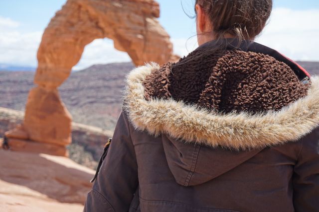 Person in Warm Jacket Exploring Scenic Arch in Desert - Download Free Stock Photos Pikwizard.com