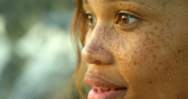 Close-up of woman's face with freckles in natural light - Download Free Stock Images Pikwizard.com